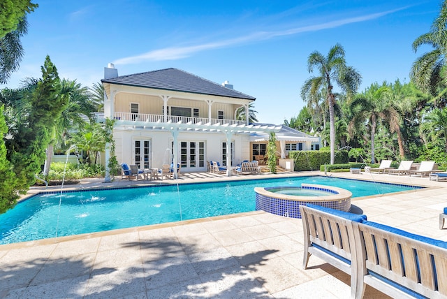 view of swimming pool with pool water feature, an in ground hot tub, and a patio area