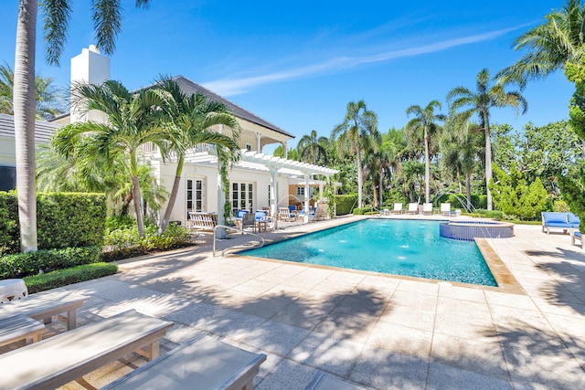 view of pool featuring a patio and french doors