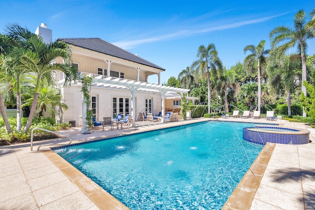 view of swimming pool with an in ground hot tub, a pergola, and a patio area