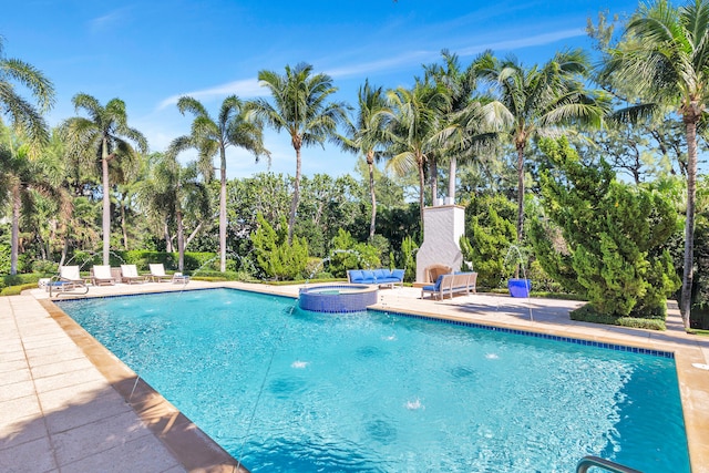 view of pool with a patio and an in ground hot tub