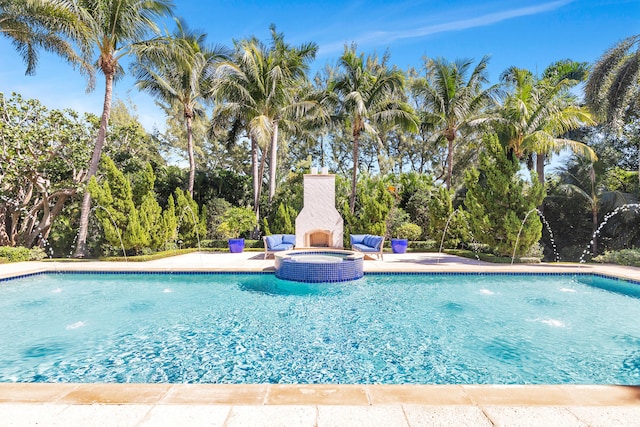 view of pool with a patio and pool water feature