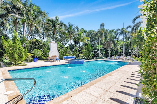 view of swimming pool featuring a patio, an in ground hot tub, and pool water feature