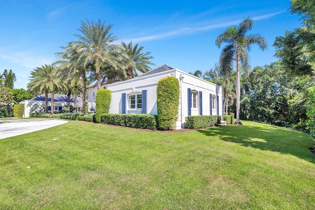 view of side of property with a lawn