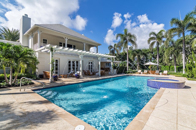 view of pool with a patio and an in ground hot tub