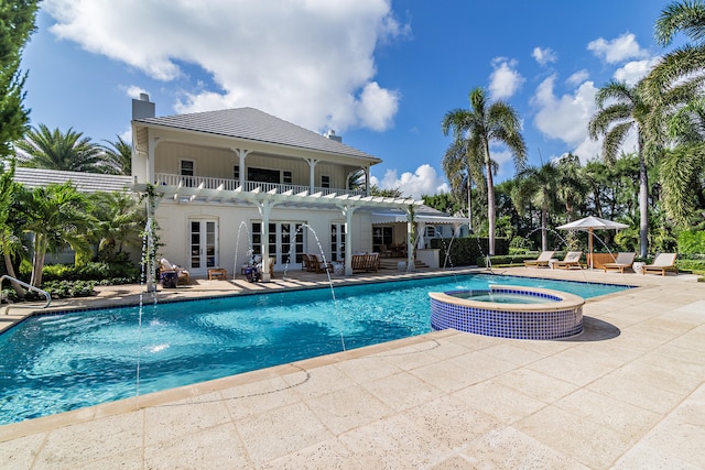 view of swimming pool with a patio, an in ground hot tub, a pergola, and pool water feature