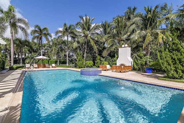 view of pool featuring an in ground hot tub and a patio area