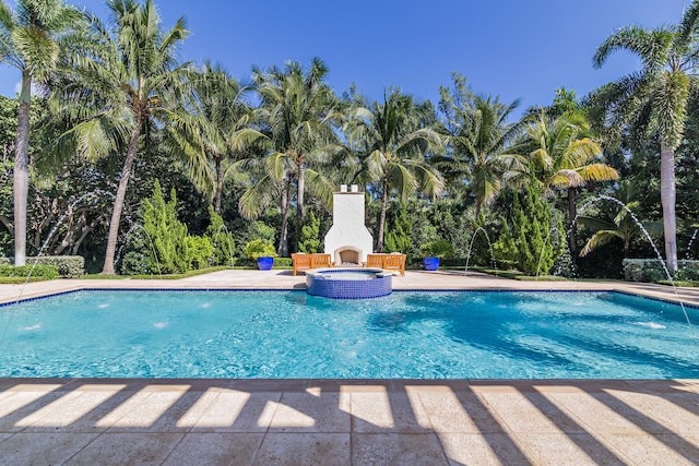 view of swimming pool with pool water feature, an in ground hot tub, and a patio area