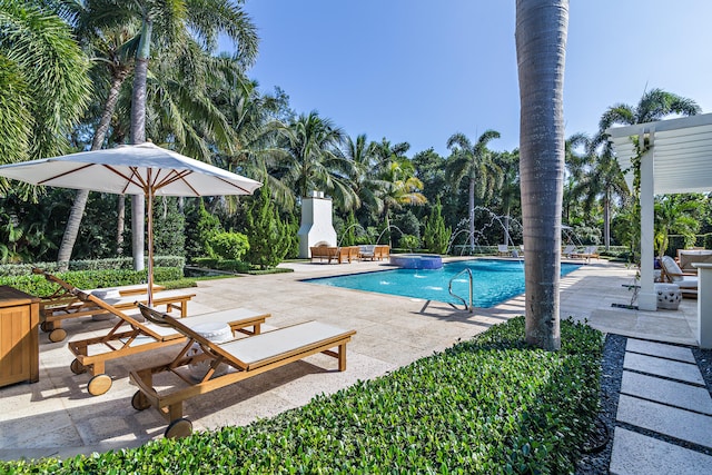 view of swimming pool with pool water feature and a patio area