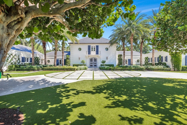 mediterranean / spanish-style house with a front lawn