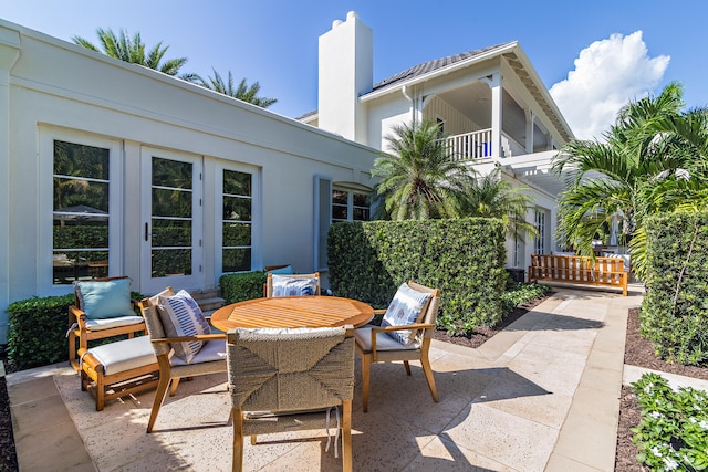 view of patio / terrace with french doors and a balcony