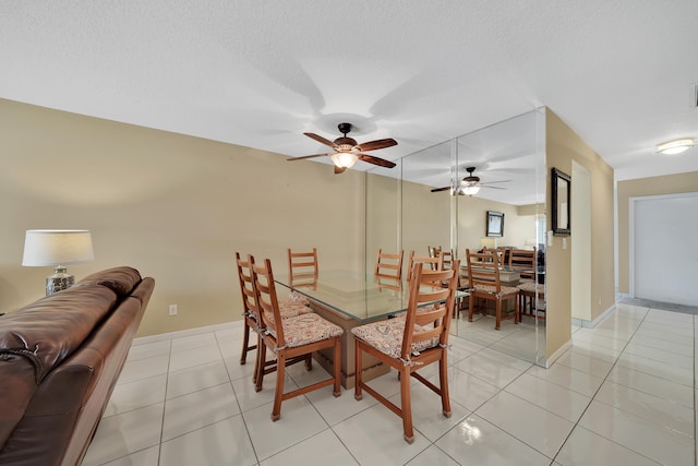 dining area with a textured ceiling, light tile patterned flooring, and ceiling fan