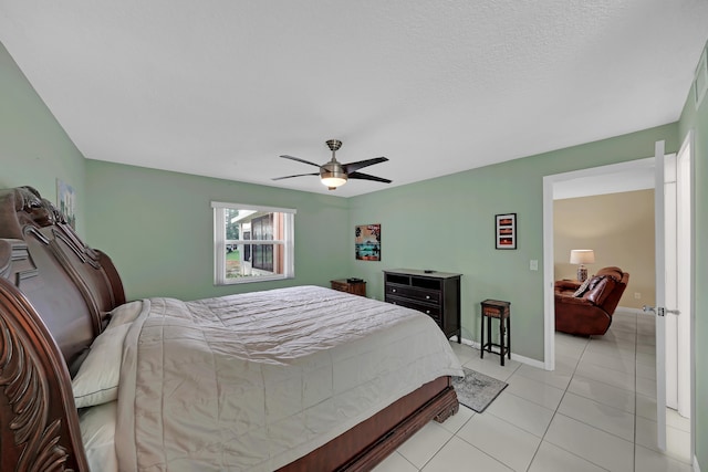 tiled bedroom featuring ceiling fan