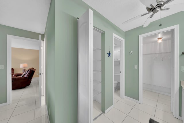 bathroom with ceiling fan, tile patterned floors, and toilet