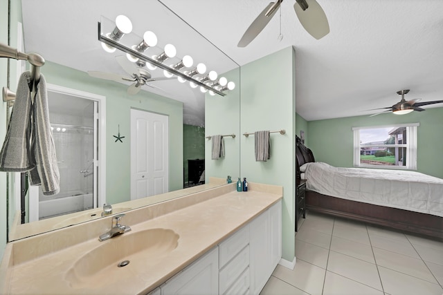 bathroom featuring tiled shower / bath combo, vanity, and tile patterned flooring