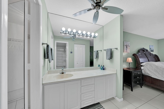 bathroom featuring vanity, tile patterned floors, and a textured ceiling