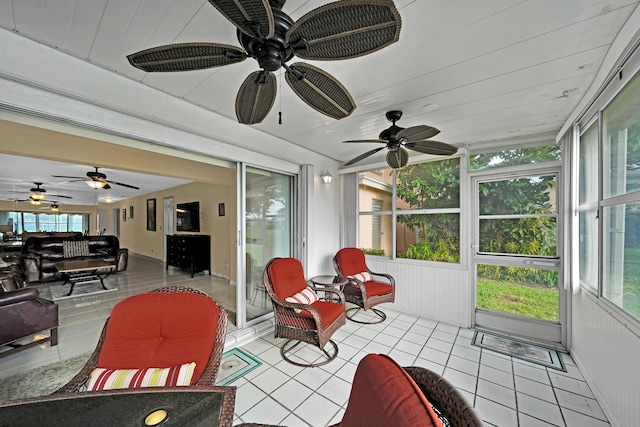 sunroom / solarium featuring ceiling fan