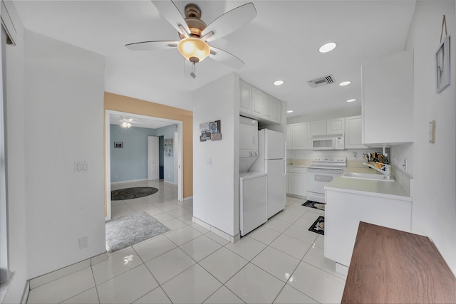 kitchen featuring white cabinetry, sink, white appliances, and light tile patterned flooring