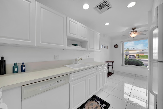 kitchen with white cabinets, white appliances, sink, and light tile patterned flooring