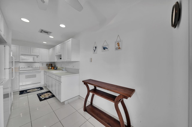 kitchen featuring sink, ceiling fan, light tile patterned flooring, white cabinetry, and white appliances