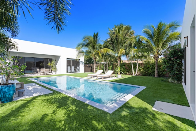 view of swimming pool featuring a yard and a patio