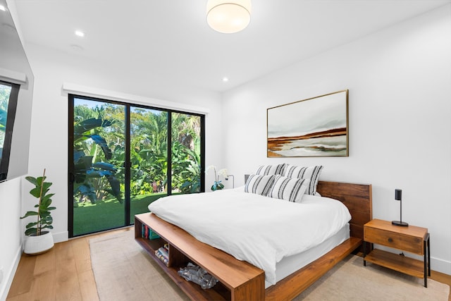 bedroom with access to outside and light hardwood / wood-style flooring