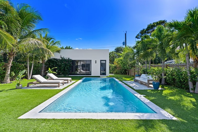 view of pool featuring an outdoor structure and a lawn