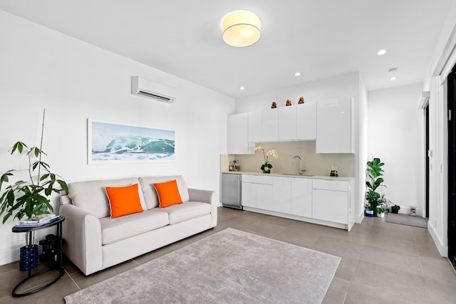 living room with an AC wall unit, sink, and light tile patterned floors