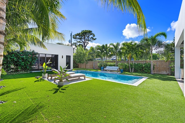 view of pool with a yard