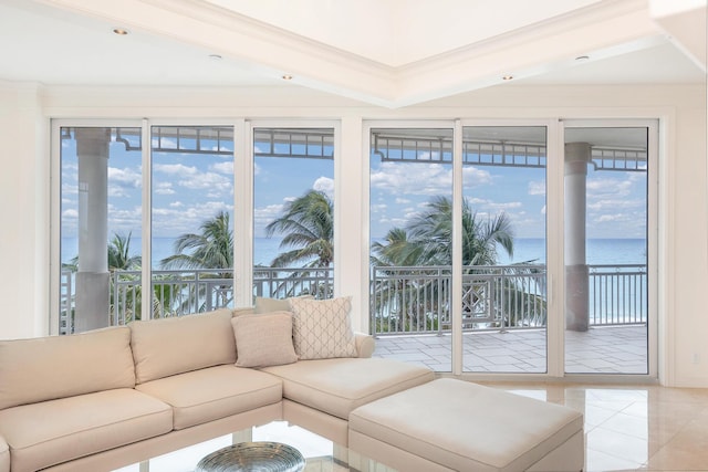 living room with a water view, crown molding, and light tile patterned flooring