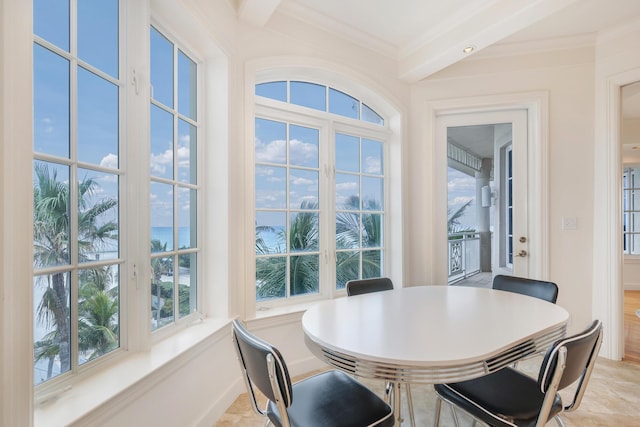 dining room with a water view, a healthy amount of sunlight, and ornamental molding