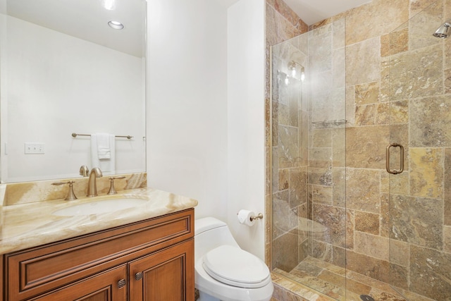 bathroom with toilet, an enclosed shower, and vanity