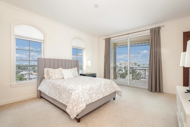 carpeted bedroom with access to outside and ornamental molding