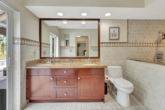 bathroom featuring vanity, tile walls, and a healthy amount of sunlight