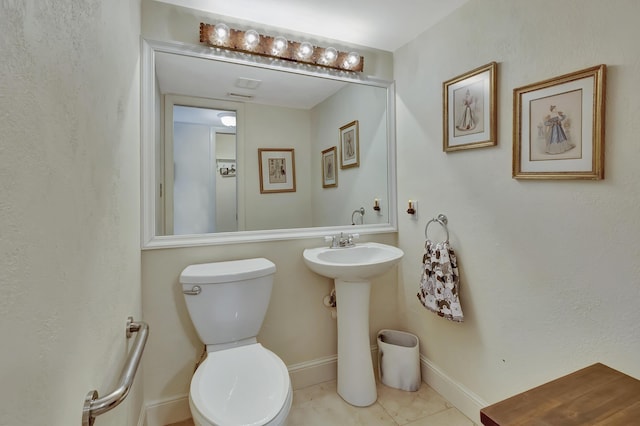 bathroom featuring tile patterned flooring and toilet