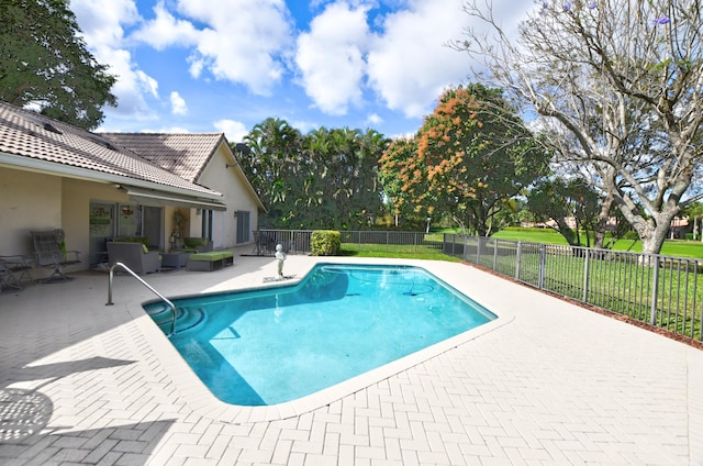 view of pool with outdoor lounge area, a yard, and a patio area