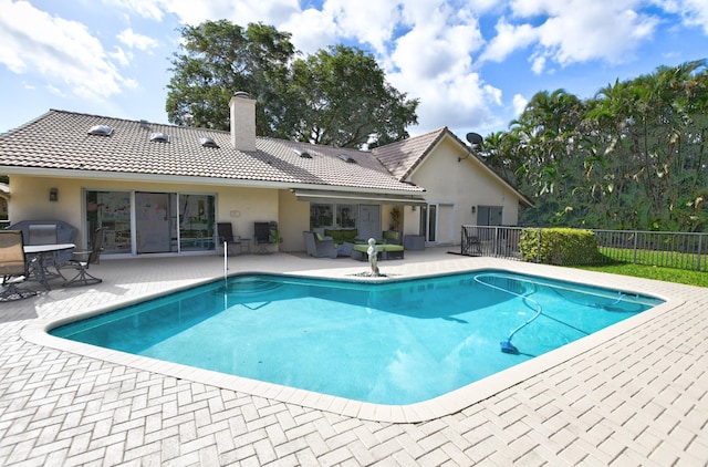 view of swimming pool with a patio area