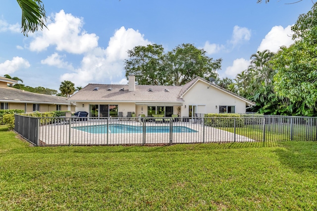 view of swimming pool with a lawn and a patio