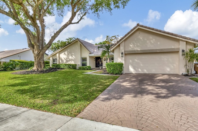 single story home featuring a front lawn and a garage