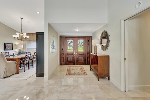 entrance foyer with french doors and a chandelier