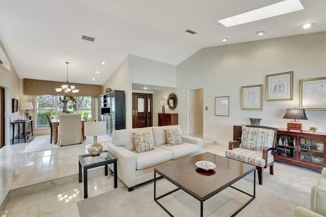 living room with lofted ceiling with skylight and a chandelier