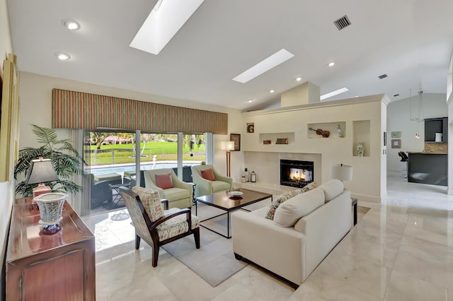 living room with vaulted ceiling and a tiled fireplace