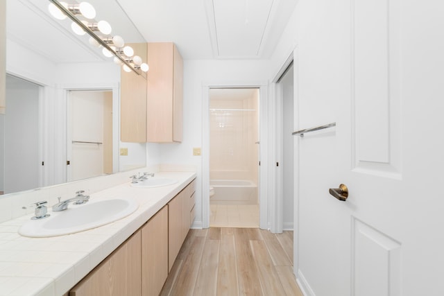 full bathroom with shower / tub combination, wood-type flooring, vanity, and toilet