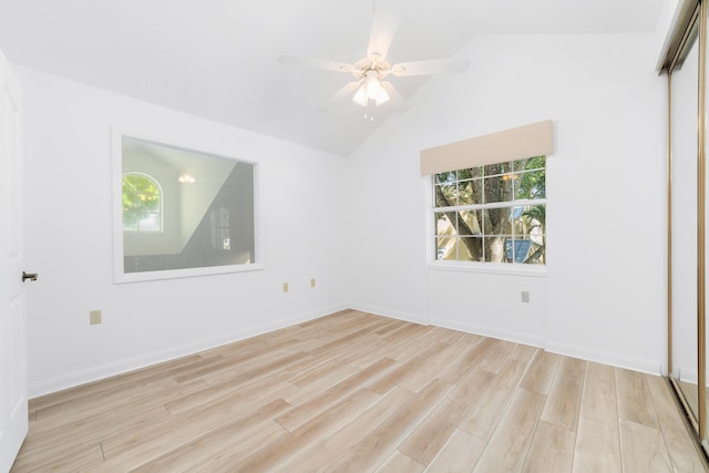 unfurnished room with vaulted ceiling, plenty of natural light, ceiling fan, and light hardwood / wood-style floors