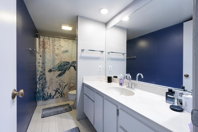 bathroom with toilet, curtained shower, vanity, and tile patterned flooring