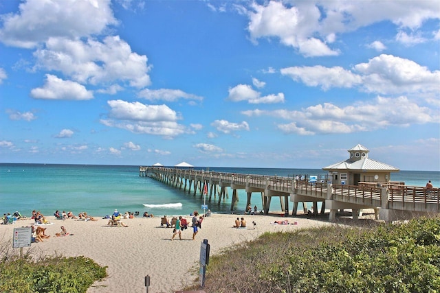 dock area with a water view and a view of the beach