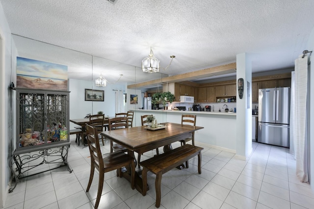 dining area featuring a textured ceiling, a chandelier, and light tile patterned floors