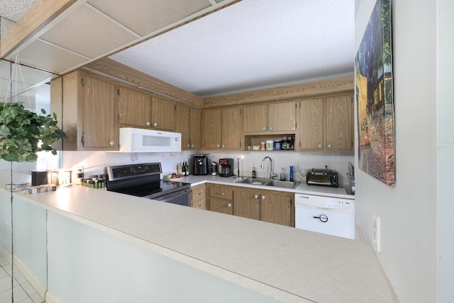 kitchen featuring kitchen peninsula, light tile patterned floors, backsplash, sink, and white appliances