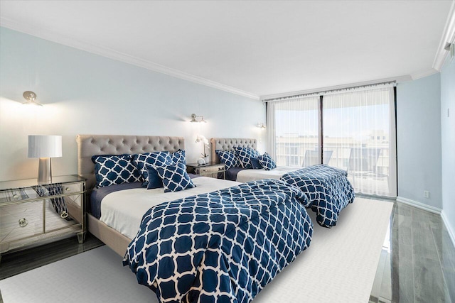 bedroom with floor to ceiling windows, wood finished floors, and crown molding