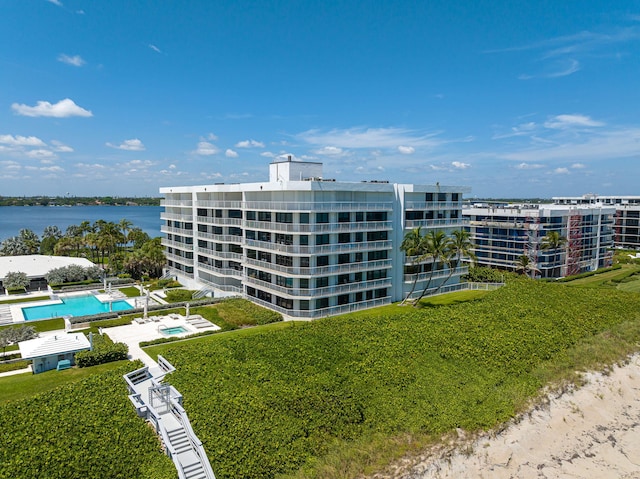 view of property featuring a water view and a community pool