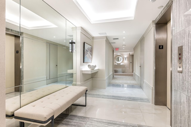 bathroom with marble finish floor, recessed lighting, a raised ceiling, and elevator